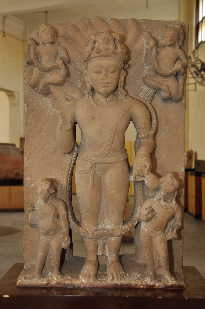 Medieval stone sculpture of the Hindu fire deity Agni with attendant figures.