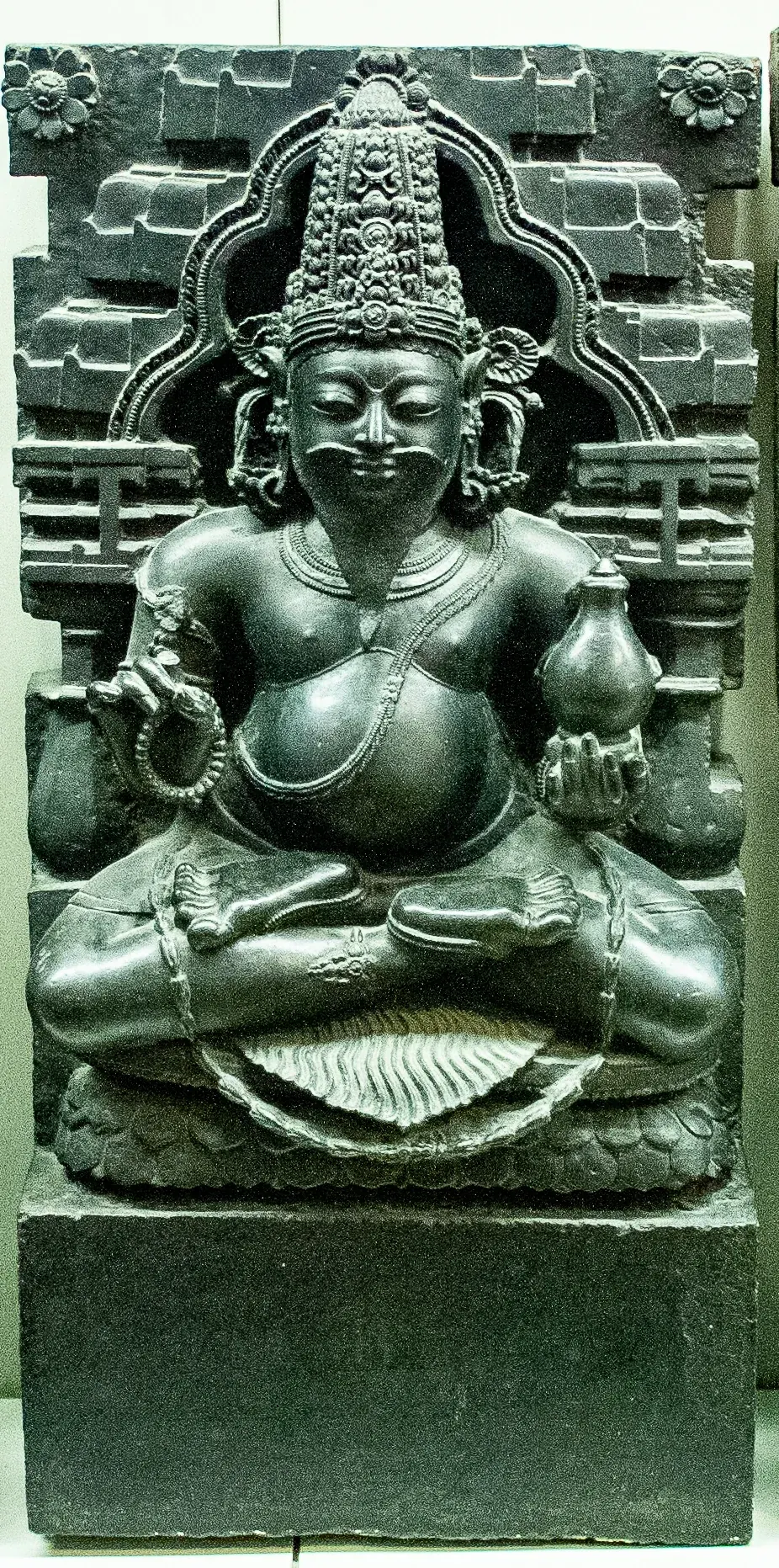 Stone Navagraha relief of Brihaspati shown as a bearded priestly figure.