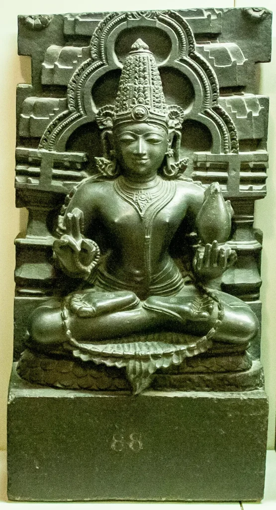Stone Navagraha relief figure identified by the source as probably Soma or Chandra, the Moon.